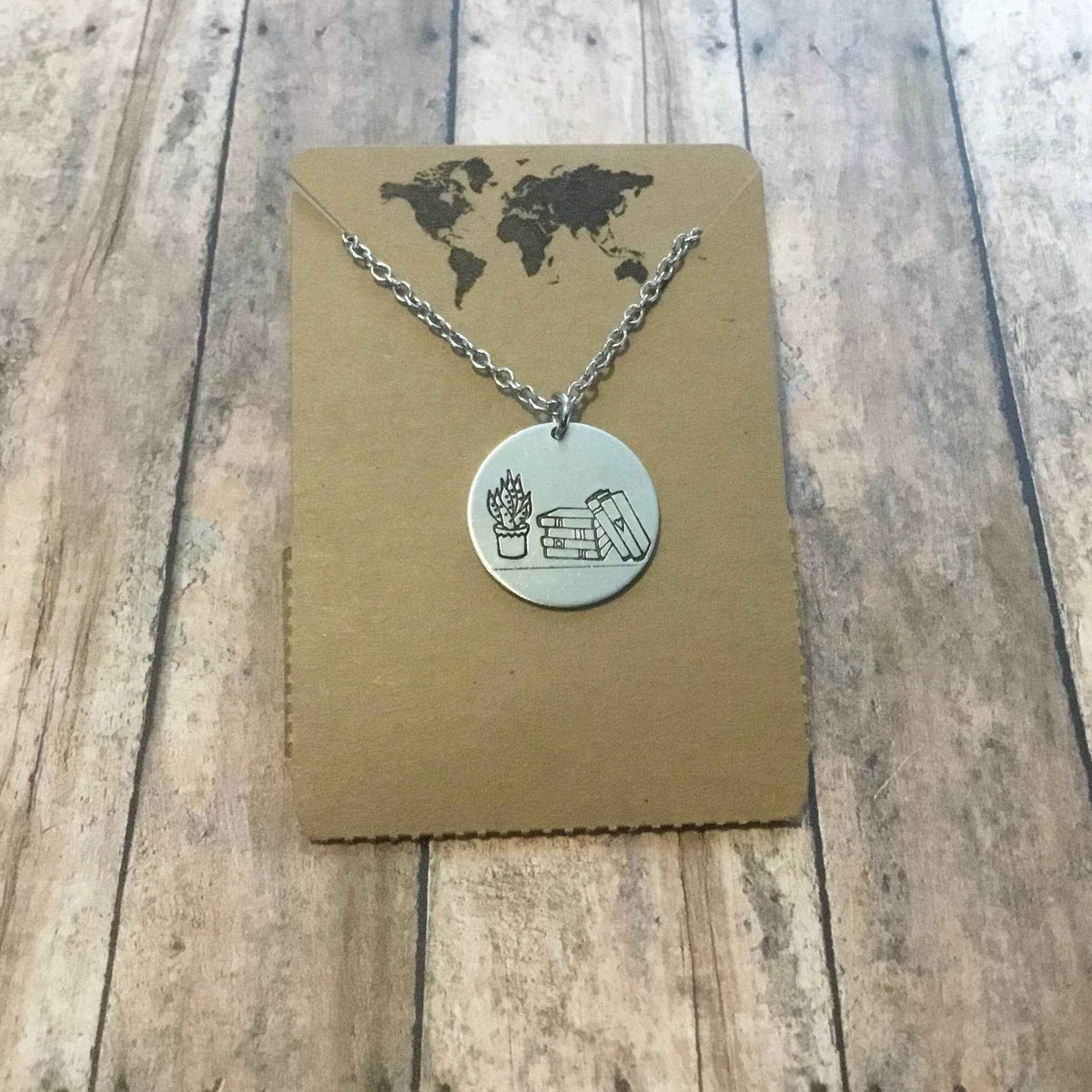 Stack of books with plant circular pendant
