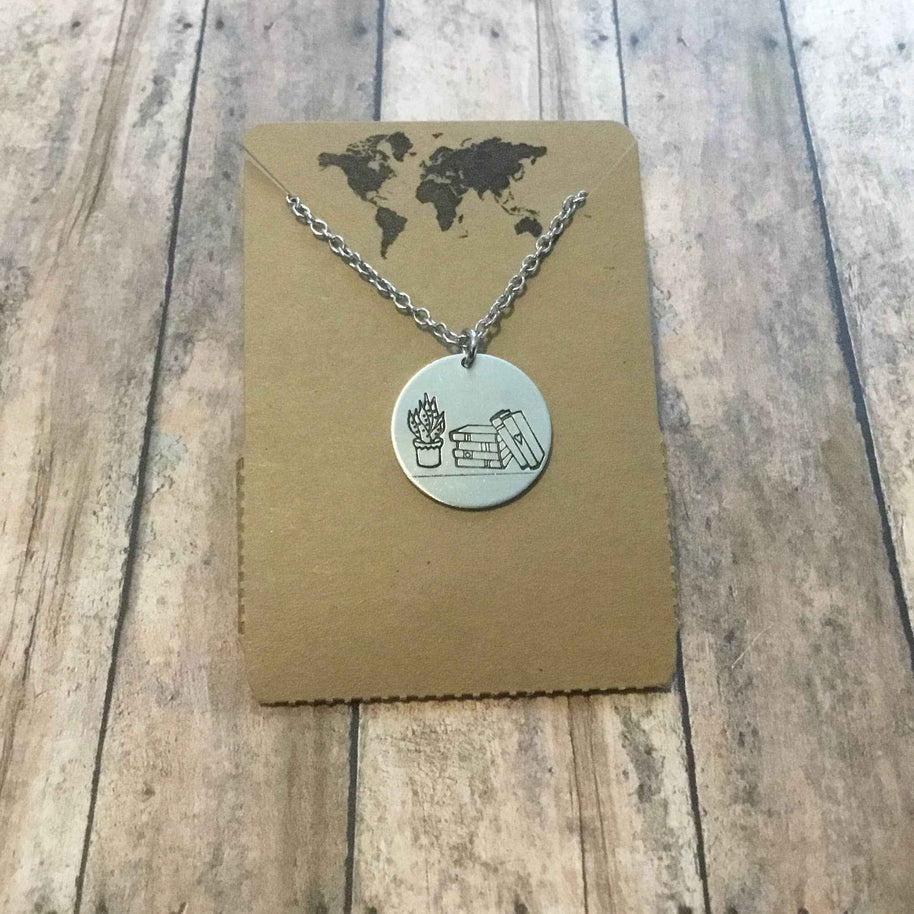 Stack of books with plant circular pendant