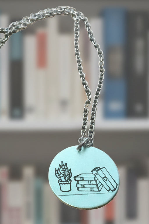Stack of books with plant circular pendant