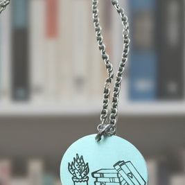 Stack of books with plant circular pendant